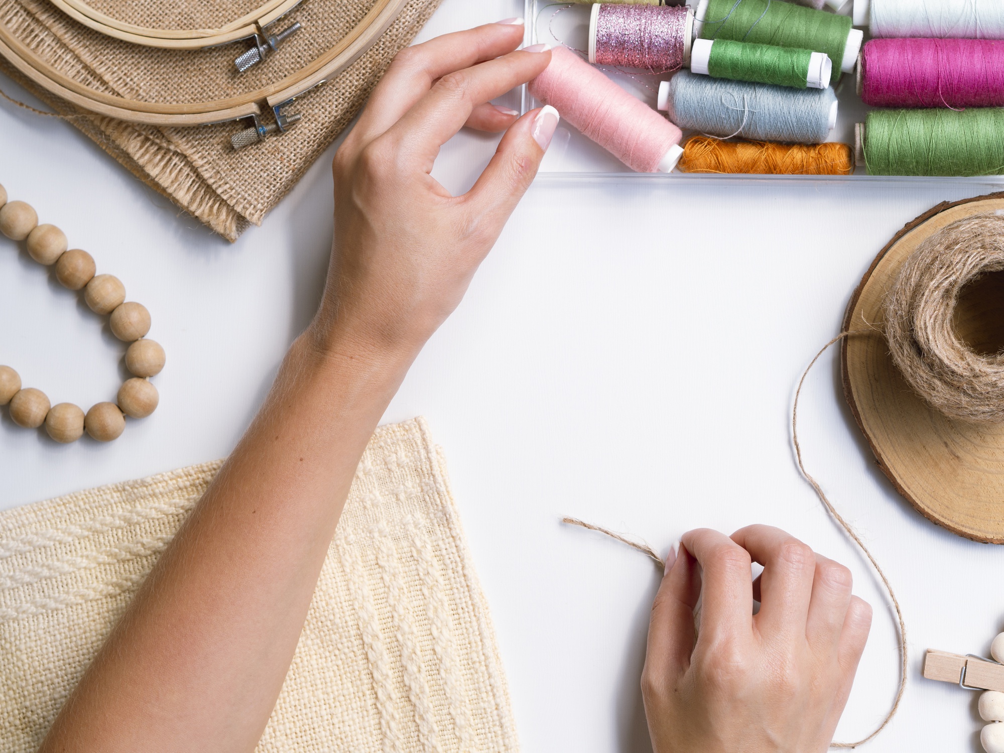 close-up of hand stitching on linen with warm threads